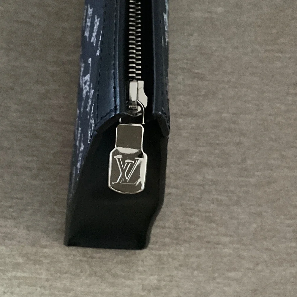 Louis Vuitton Chapman Lion Pochette Voyage